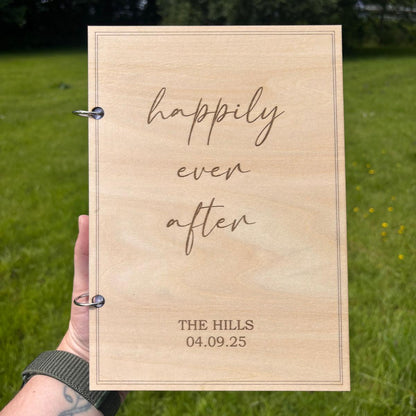 Personalised wooden wedding card keepsake book with Happily Ever After engraving, couple's surname, wedding date and metal binding rings.