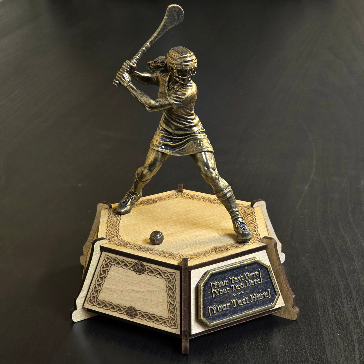 Personalised camogie trophy with bronze-effect player figure, engraved wooden base and custom plaque