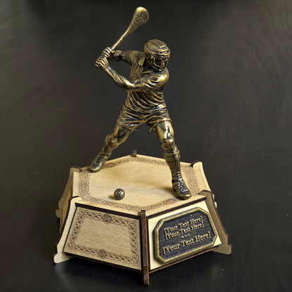 Personalised hurling trophy with bronze-effect player figure, engraved wooden base and custom plaque